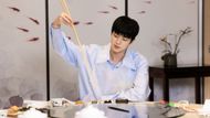 Scene from Run Jin - Jin eating with long chopsticks in one of the program's challenges | Source: Weverse